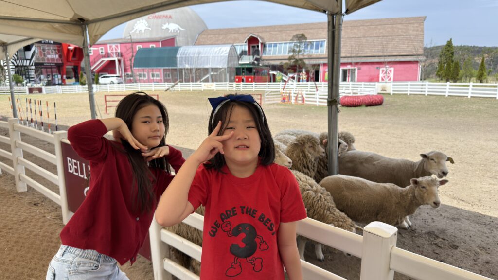 The girls posing with the sheep