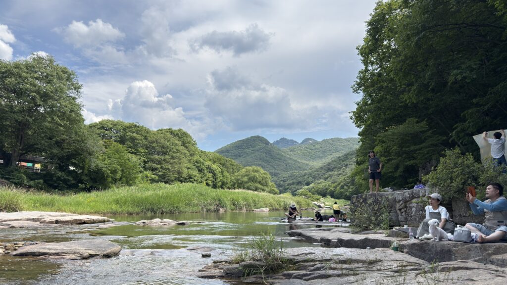 Showing the beautiful valley scenery and the family relaxing on the mat