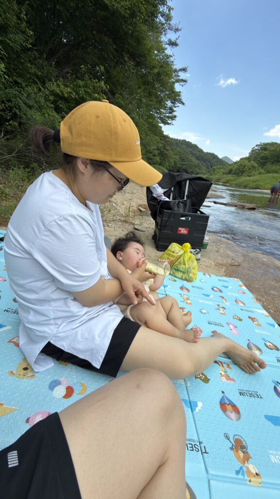 Dad taking a selfie with the baby by the water