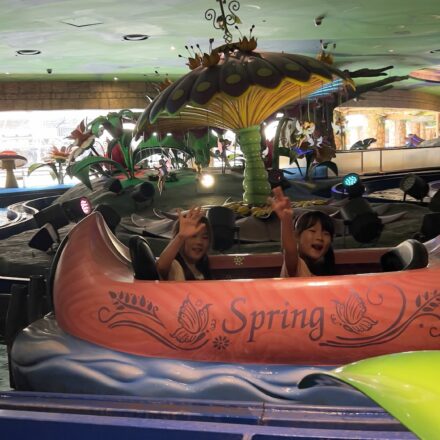 Lotte World with kids enjoying a colorful indoor boat ride