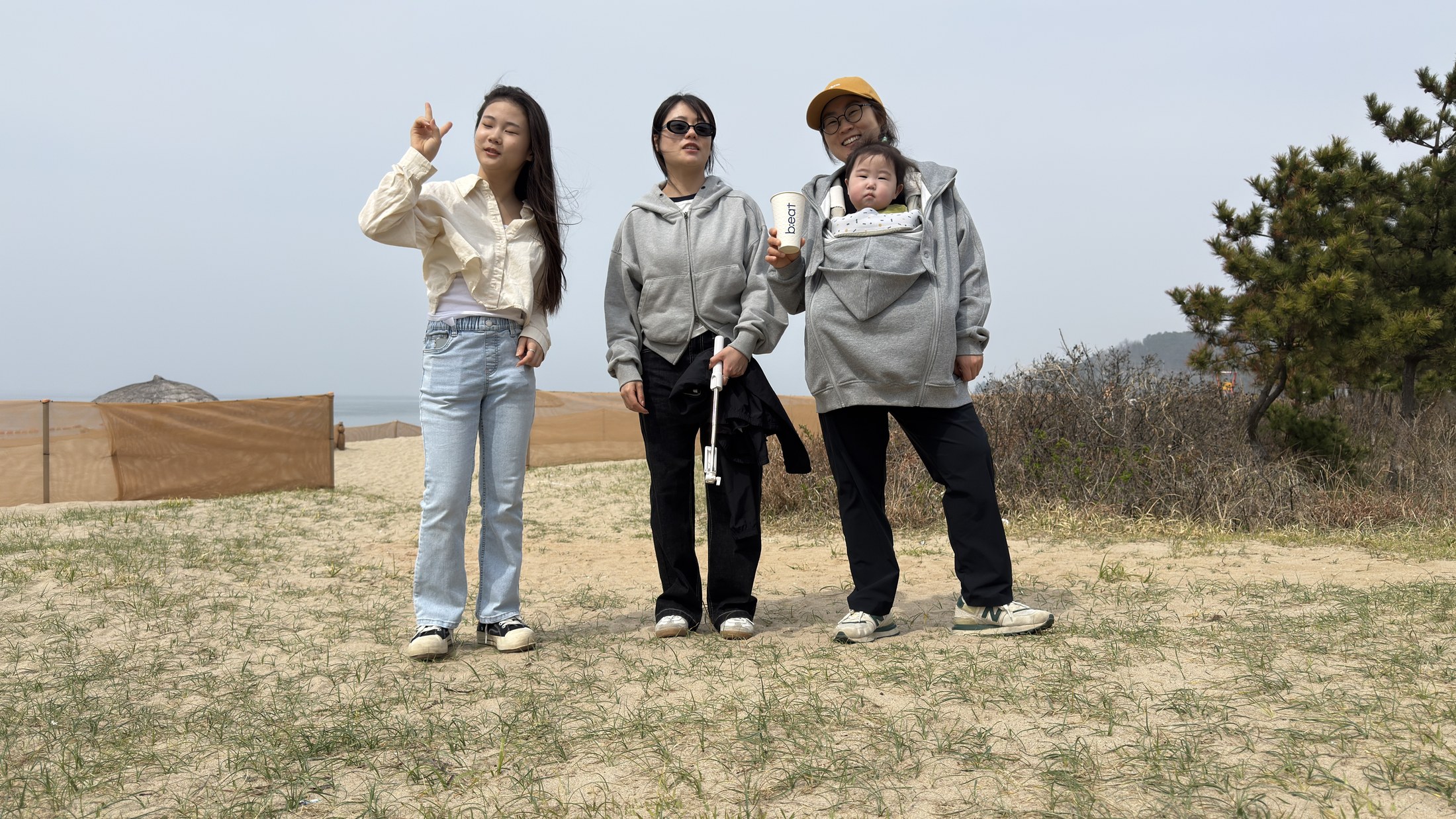 Family members posing at Byeonsan Beach during a spring trip
