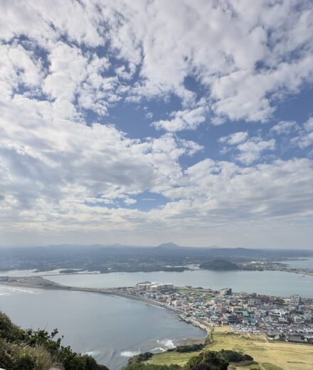 Seongsan village and the blue coastline viewed from high on Seongsan Ilchulbong